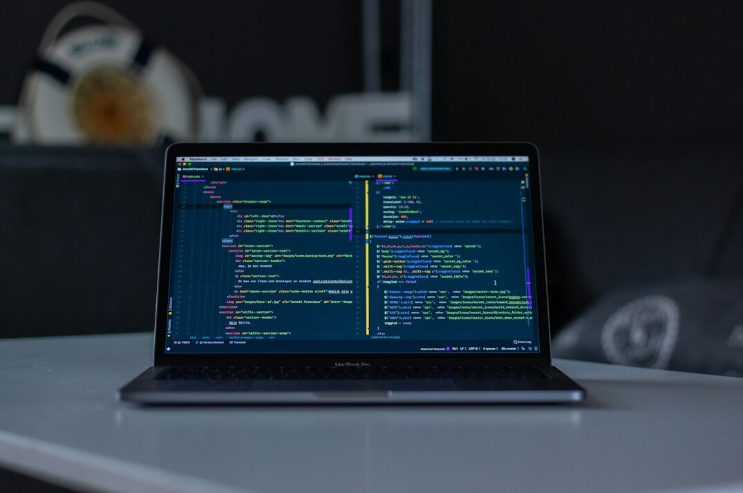developer coding on laptop